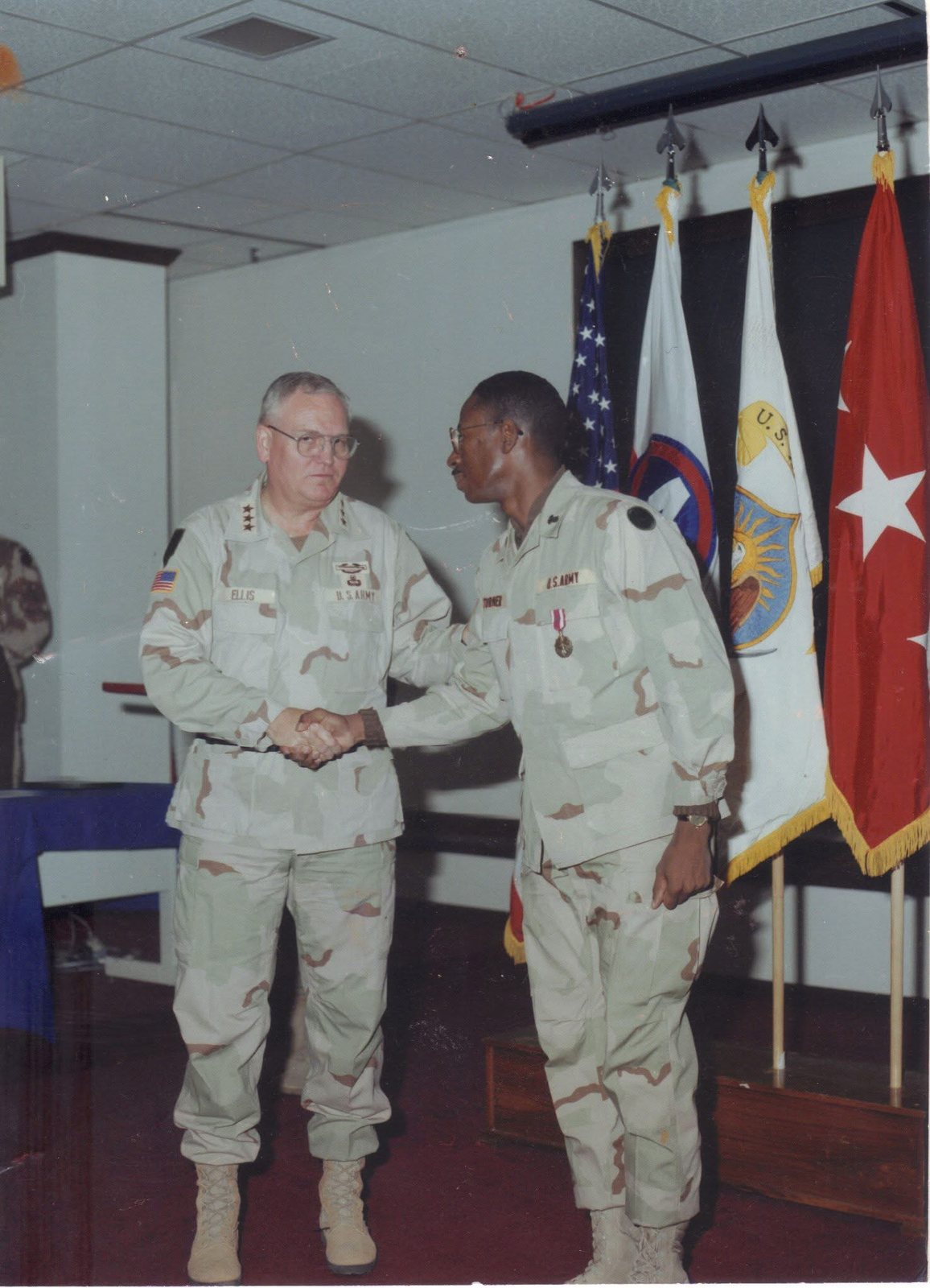Larry D. Turner receiving a medal from a U.S. Army Lieutenant General