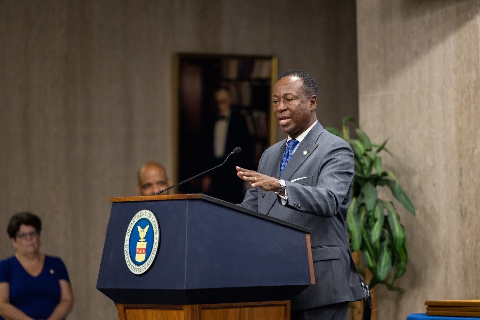 Larry D. Turner speaking at a Department of Labor podium