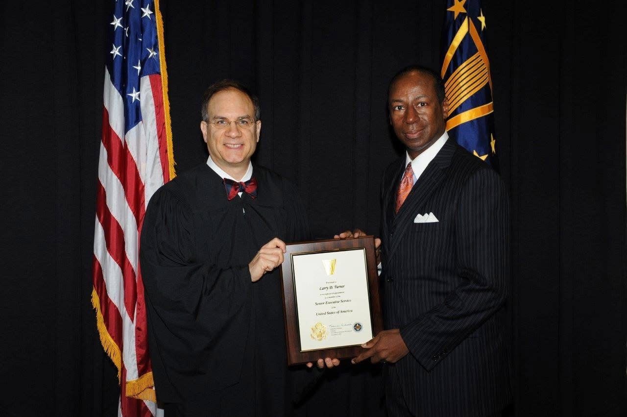 Larry D. Turner being inducted into the Senior Executive Service